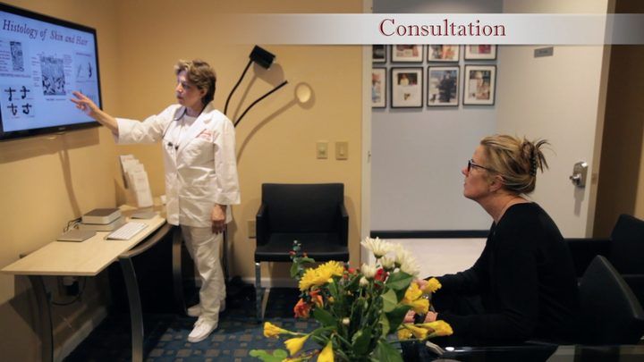 A practitioner at Berenice explaining a treatment to a client during a consultation