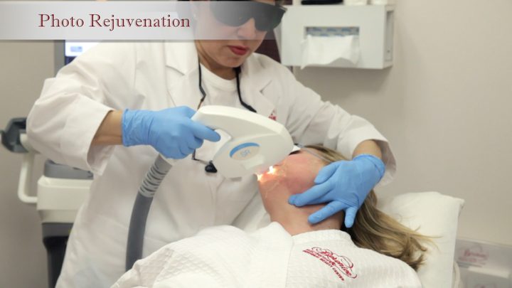 A practitioner at Berenice performing an Elos Plus treatment on a client's face
