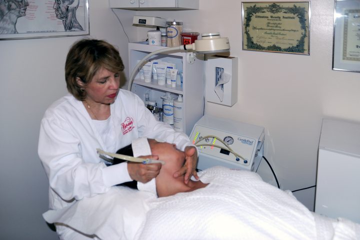 An aesthetician at Berenice performing a micro-dermabrasion treatment